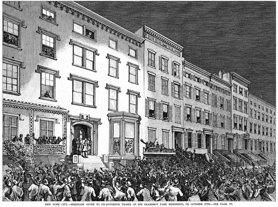 An 1877 engraving of a crowd outside Samuel Tilden’s house; No. 13 stands immediately to its right with a high stoop and narrow windows.