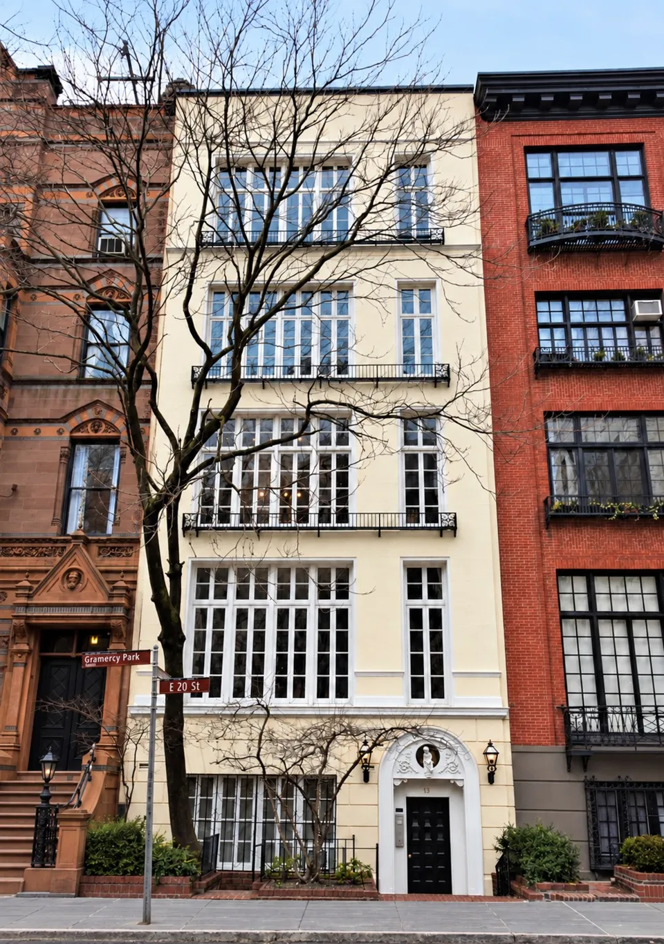 The pale façade and broad studio windows of 13 Gramercy Park South, between the National Arts Club and No. 12.