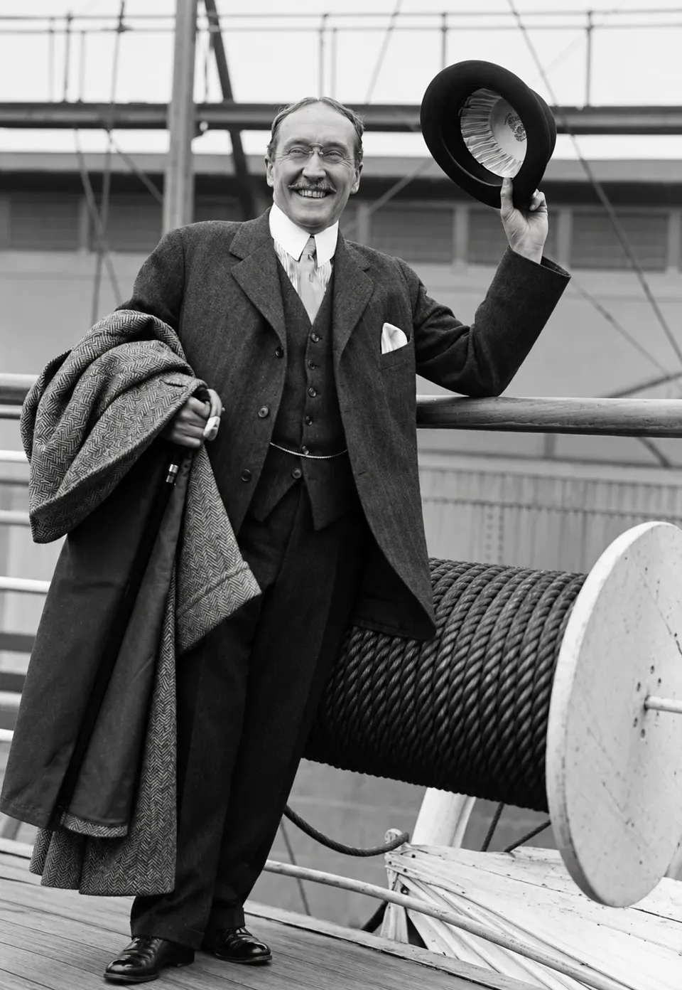 James Watson Gerard III smiling and raising his hat aboard a ship.