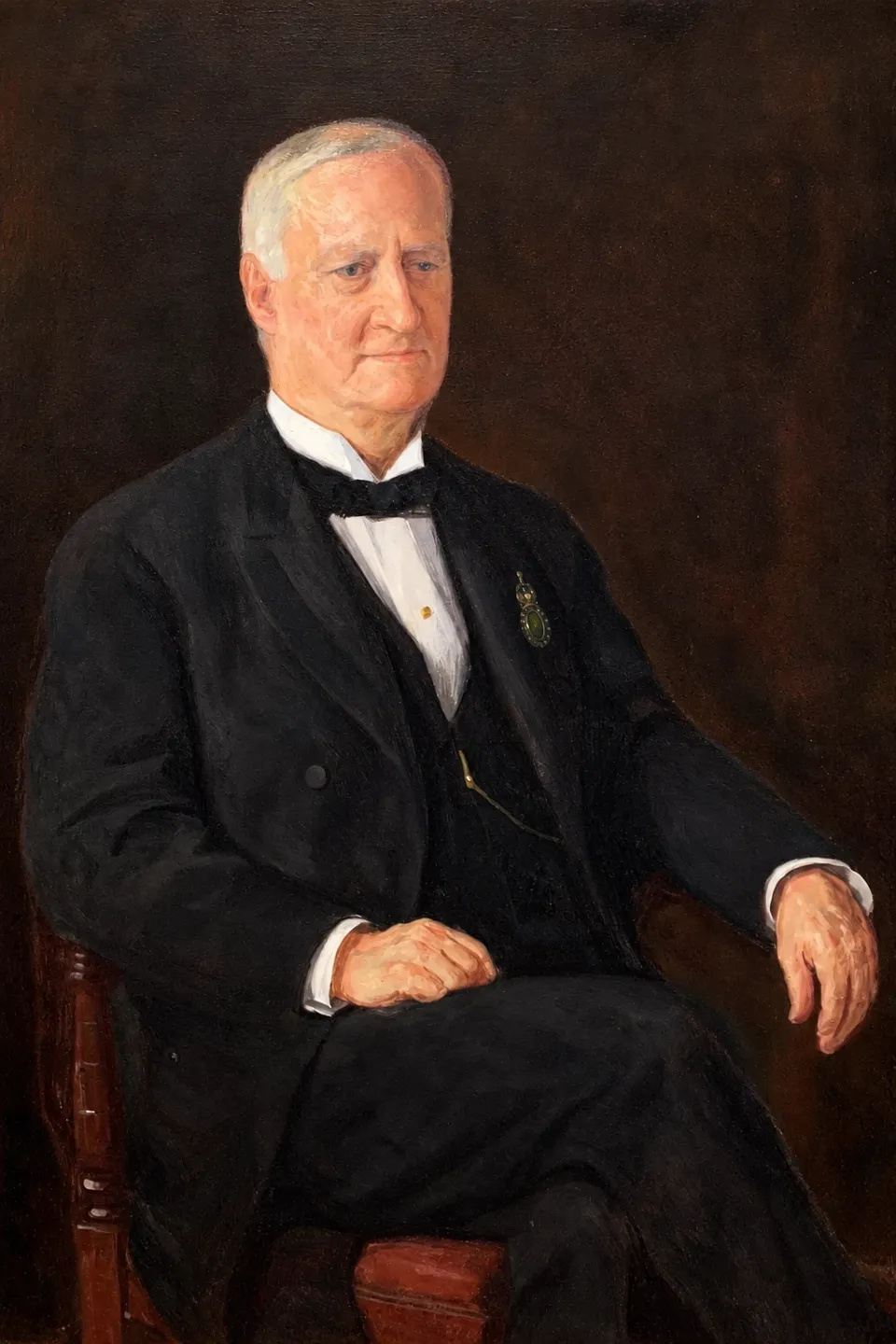 Painted portrait of Frederick Samuel Tallmadge seated in a dark suit with a society insignia.