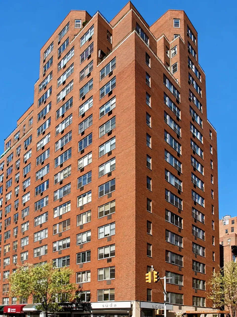The red-brick façade and stepped upper stories of 32 Gramercy Park South at Third Avenue.