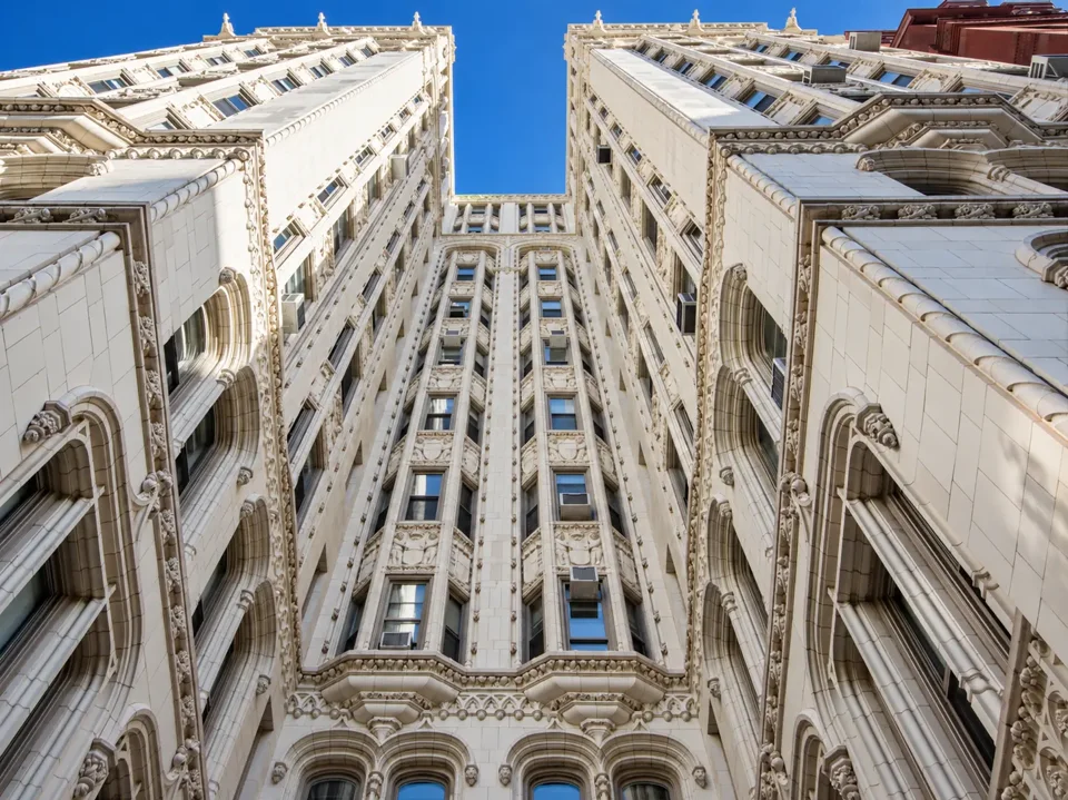 An upward view between the two wings of 36 Gramercy Park East, showing its projecting windows and terra-cotta ornament.