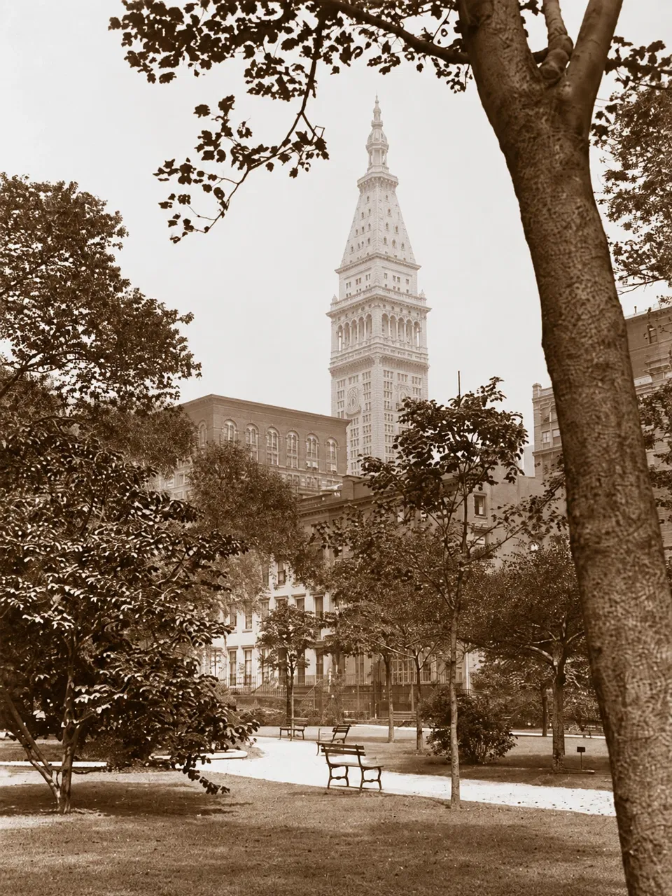 Gramercy Park with low buildings and the Metropolitan Life tower beyond, in a historic lantern slide.