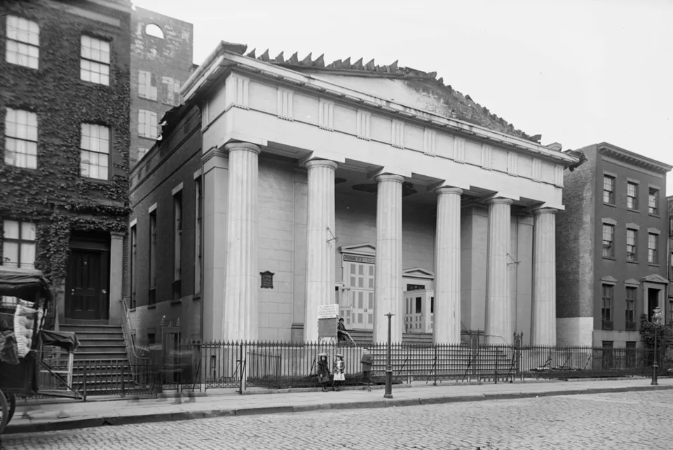 The Greek Revival portico of the Village Presbyterian Church in 1902, with fire-damaged roof timbers exposed above.