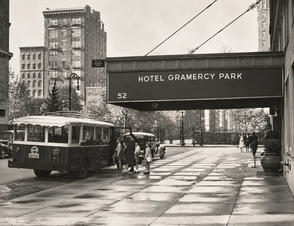 Children beside the Friends’ Seminary school bus under the Hotel Gramercy Park entrance canopy.