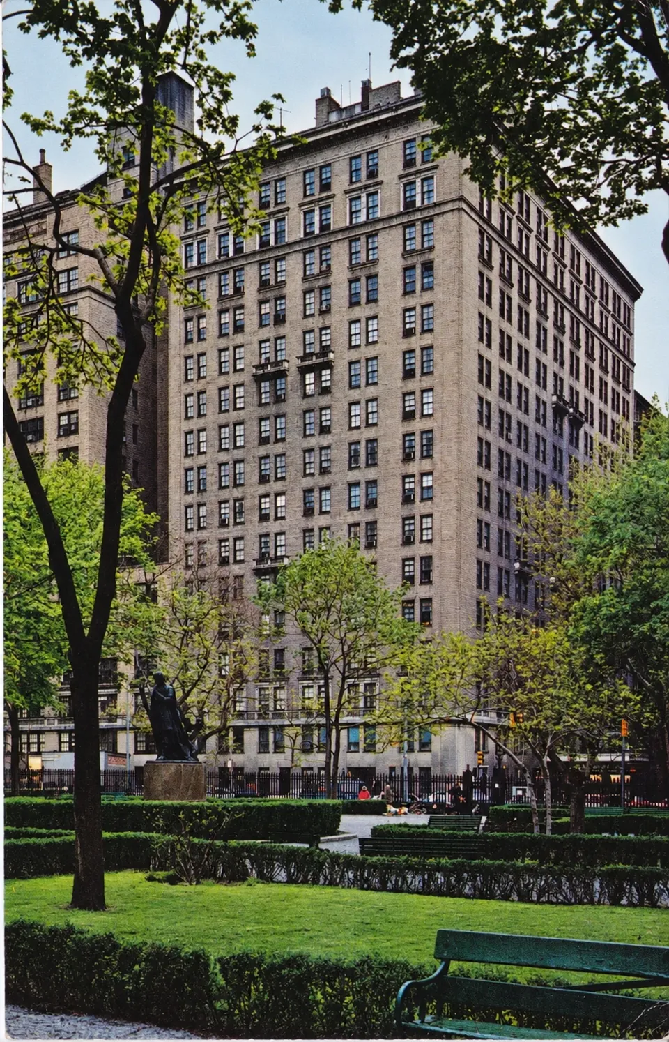A vintage color view of the hotel behind the Park’s trees, lawns, benches and Edwin Booth statue.