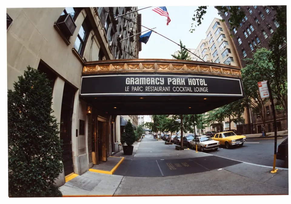 The Gramercy Park Hotel entrance canopy with Le Parc Restaurant and Cocktail Lounge lettering, with taxis on the street.