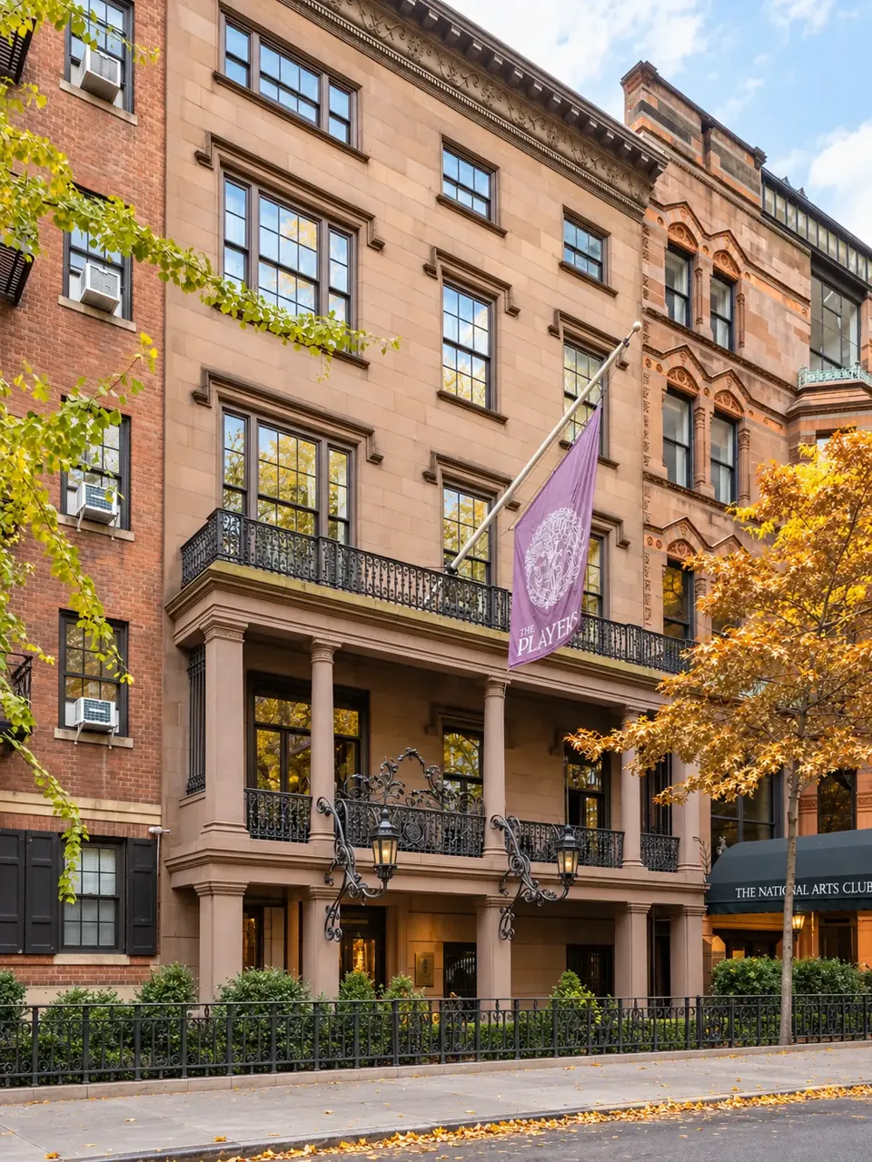 The full facade of The Players at 16 Gramercy Park South, showing the columned porch, iron balconies and upper stories.