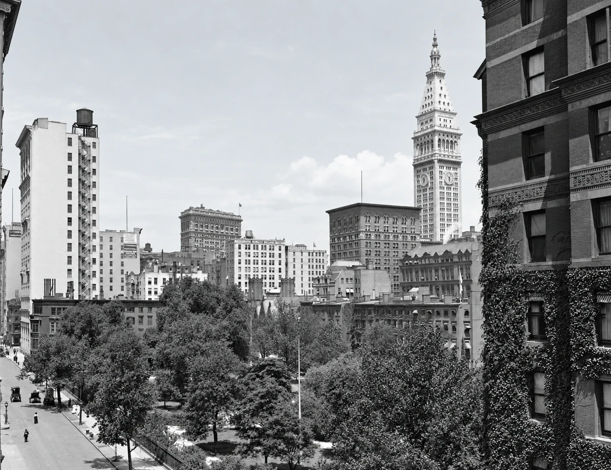 An elevated historic view across Gramercy Park’s trees toward the Metropolitan Life tower.
