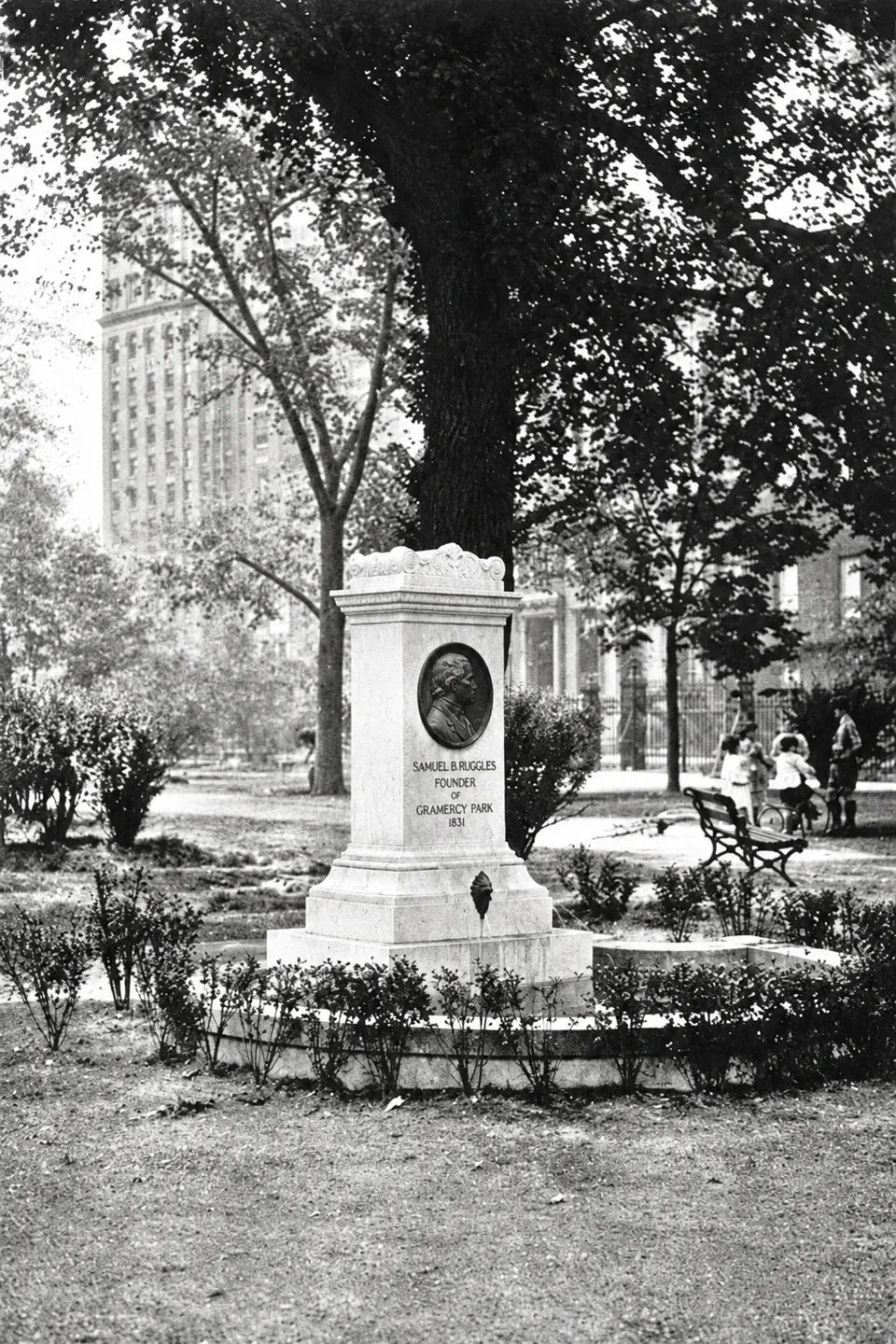 The Ruggles Fountain by 1921, with its oval portrait, curved basin and neighbors on the path behind it.