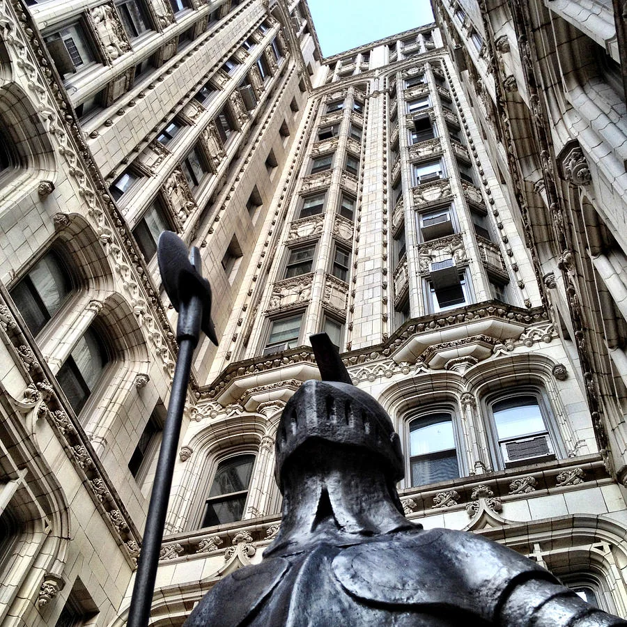 An armored knight and its halberd fill the foreground beneath the ornate, converging walls of 36 Gramercy Park East.