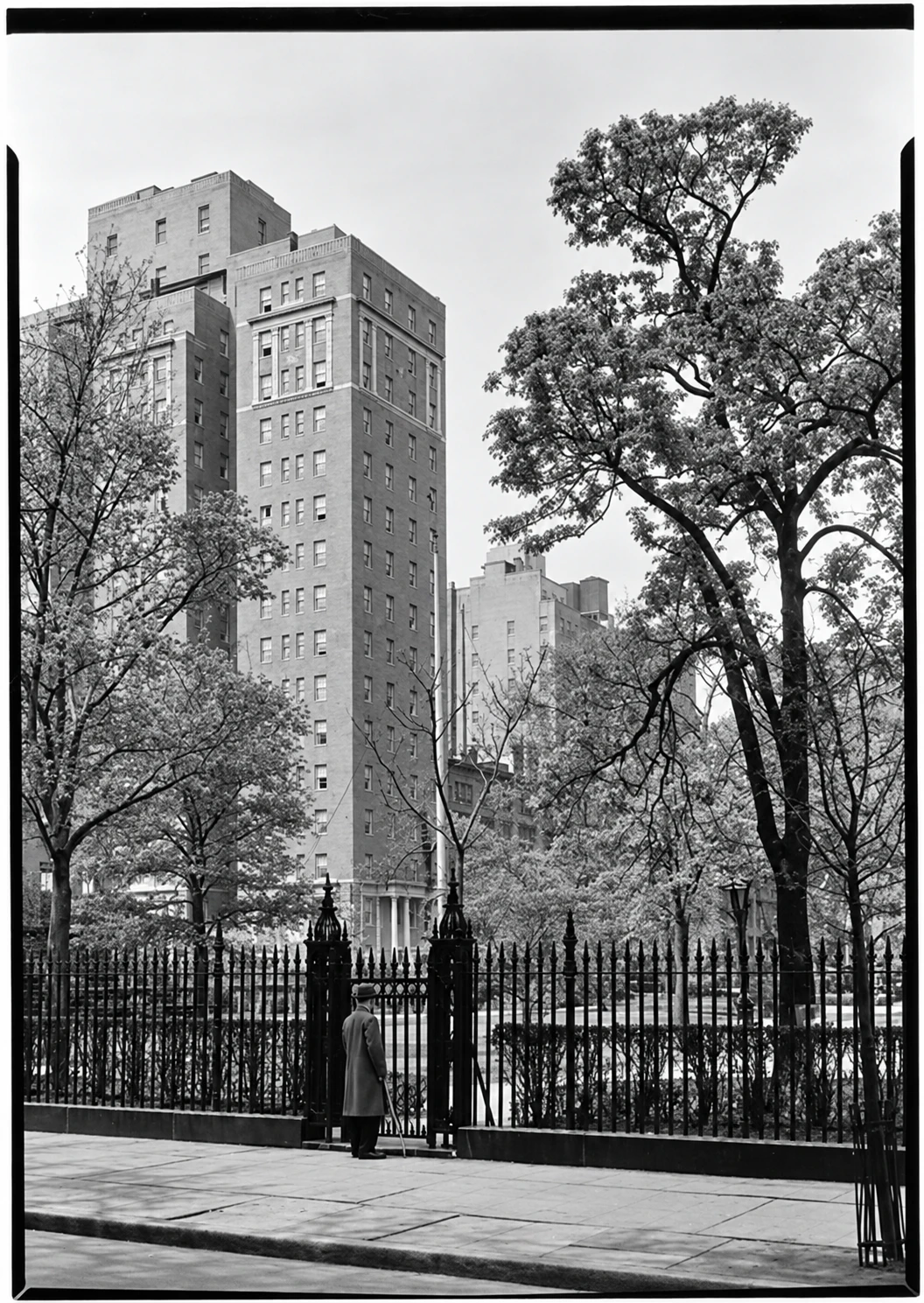 The new Parkside building in 1929, seen across the Park fence, with a pedestrian at the gate.