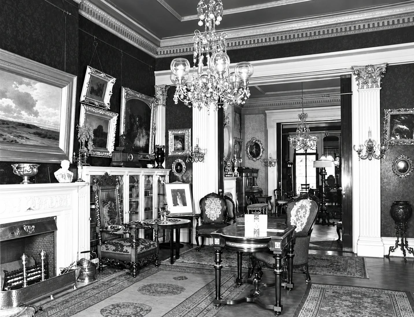 Vanderpoel’s front parlor: paintings, a marble mantel, and a long view through columned openings.