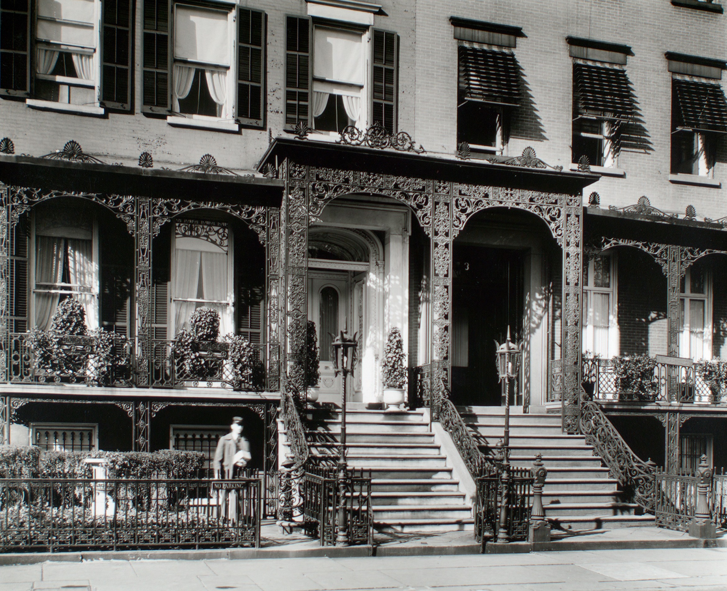The entrances to Nos. 4 and 3 Gramercy Park West in 1935, with their ornamental iron canopy, stoops and shutters; the number 3 is visible above the right-hand door.