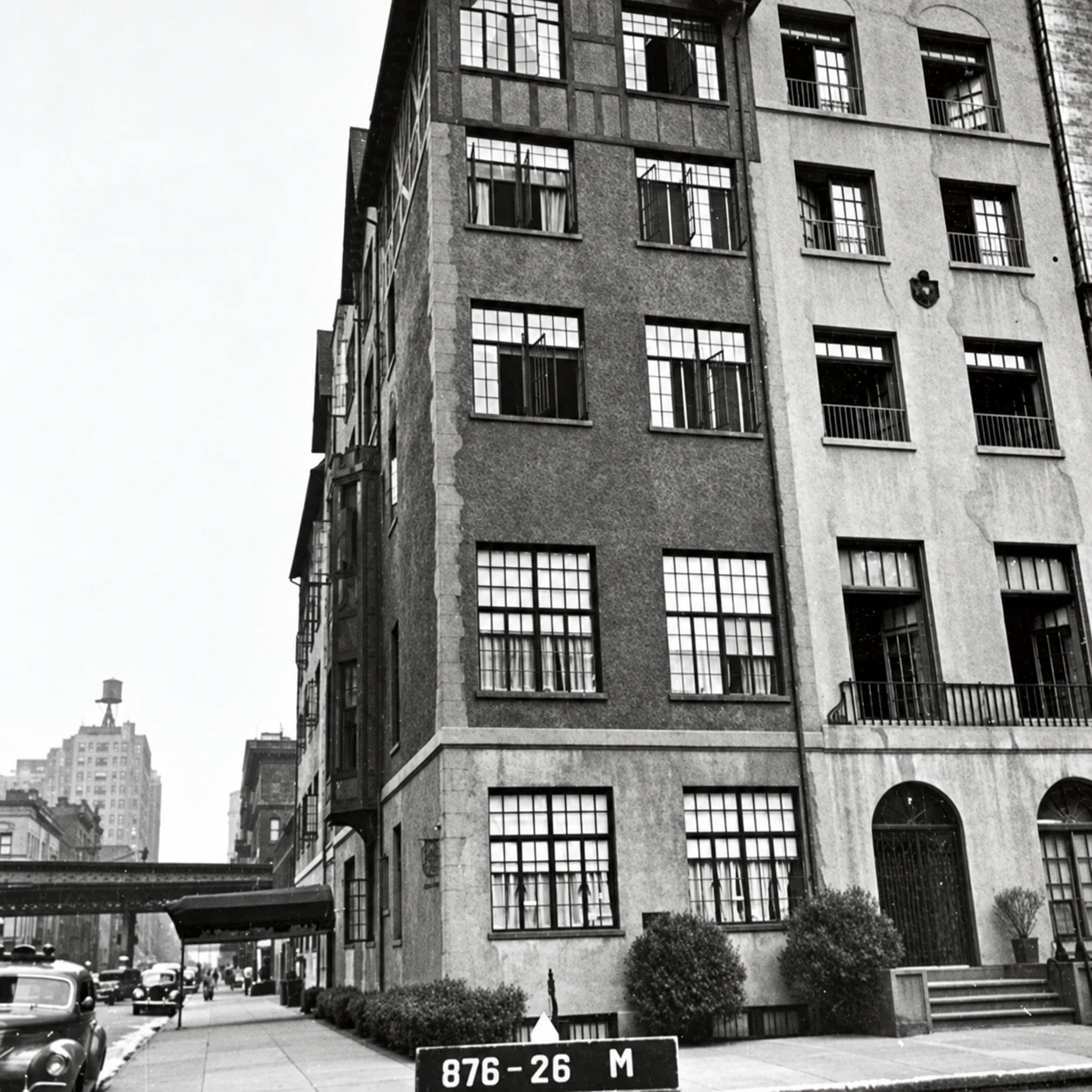Black-and-white tax photograph of 38 Gramercy Park with stucco walls, dark timber trim, and the elevated railway in the distance.