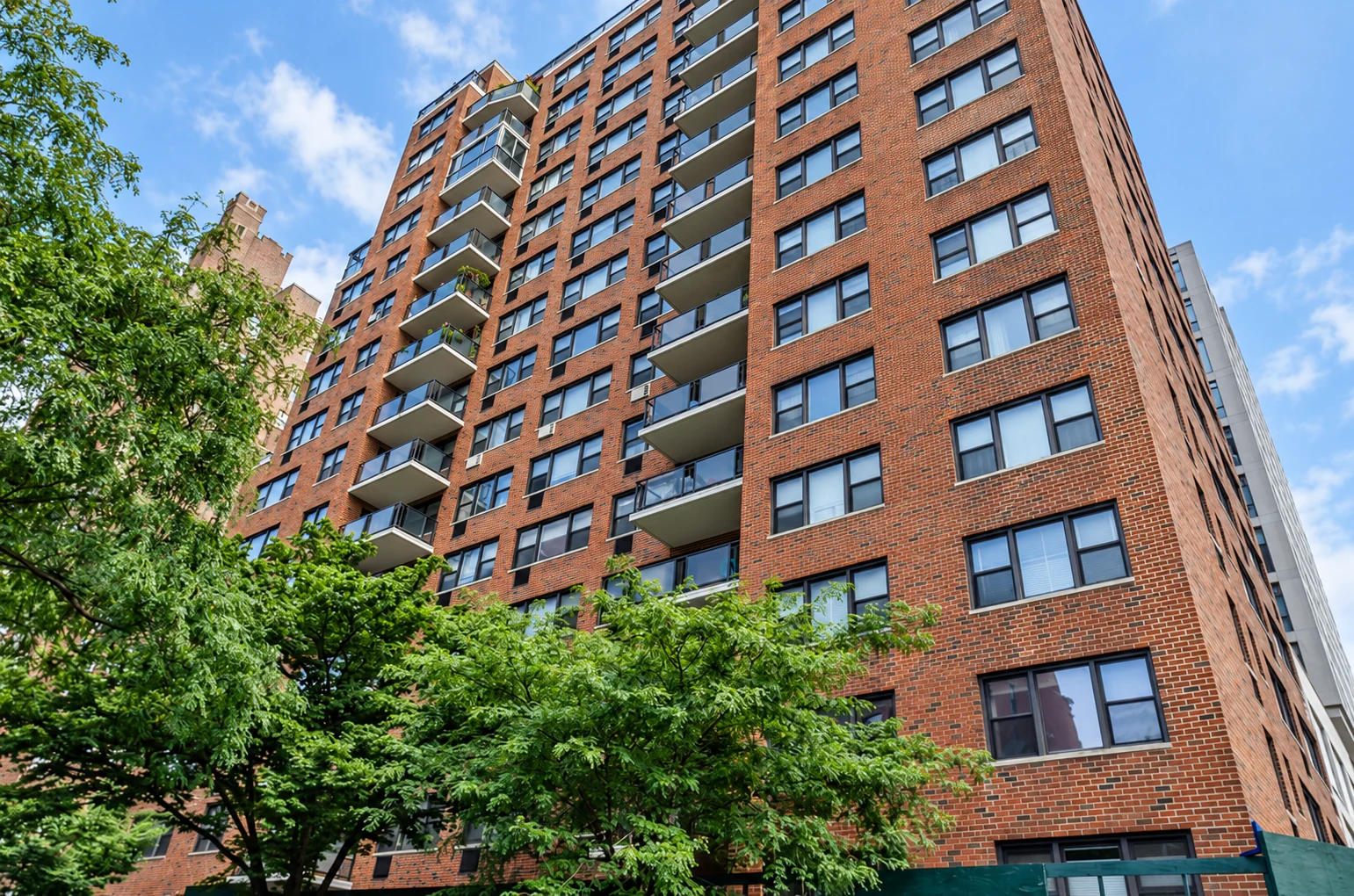 Brick walls, corner windows and stacked balconies at 39 Gramercy Park North.