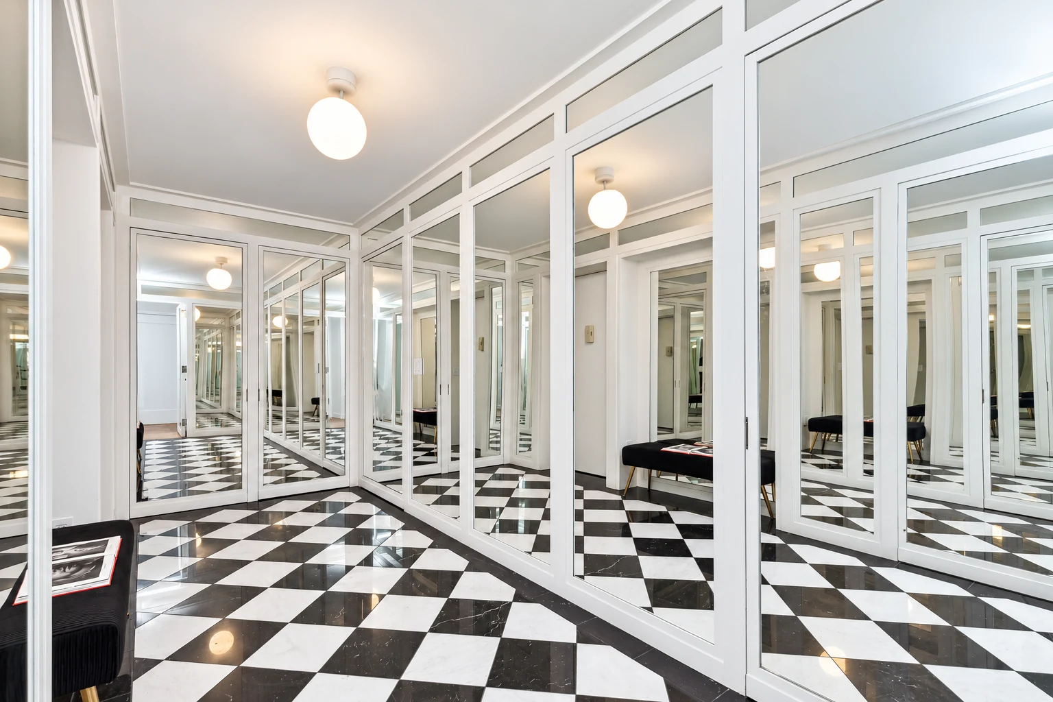 Mirrored hallway and black-and-white floor in Jennifer Rubell’s apartment, photographed in 2023.