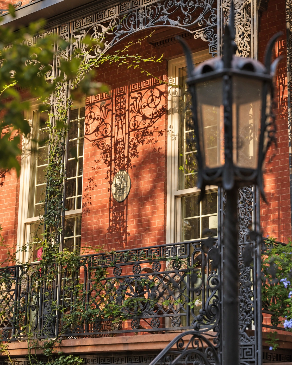 One of the mayor’s lamps in front of the elaborate iron porch and red-brick facade.