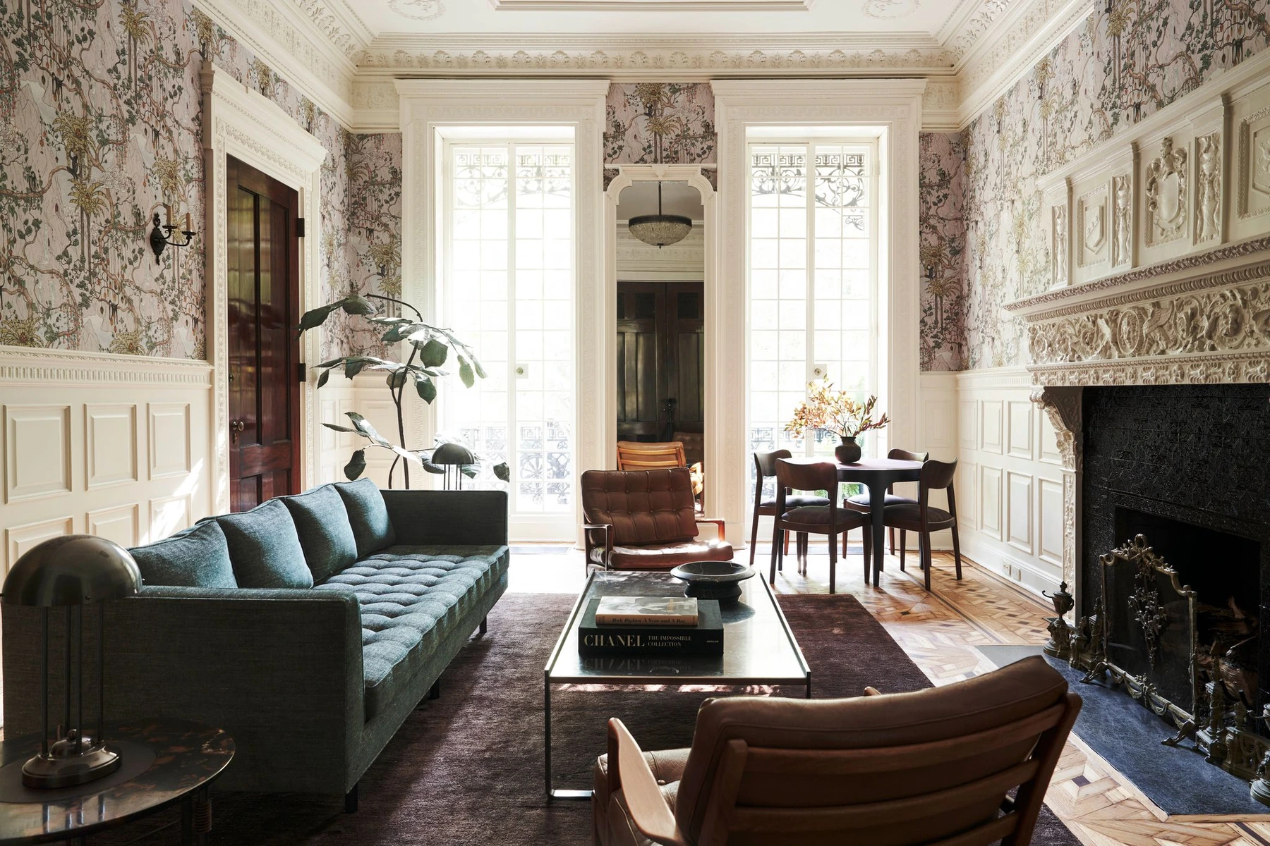The restored parlor with ornate plasterwork, a marble fireplace, David Wiseman wallpaper and contemporary furniture.