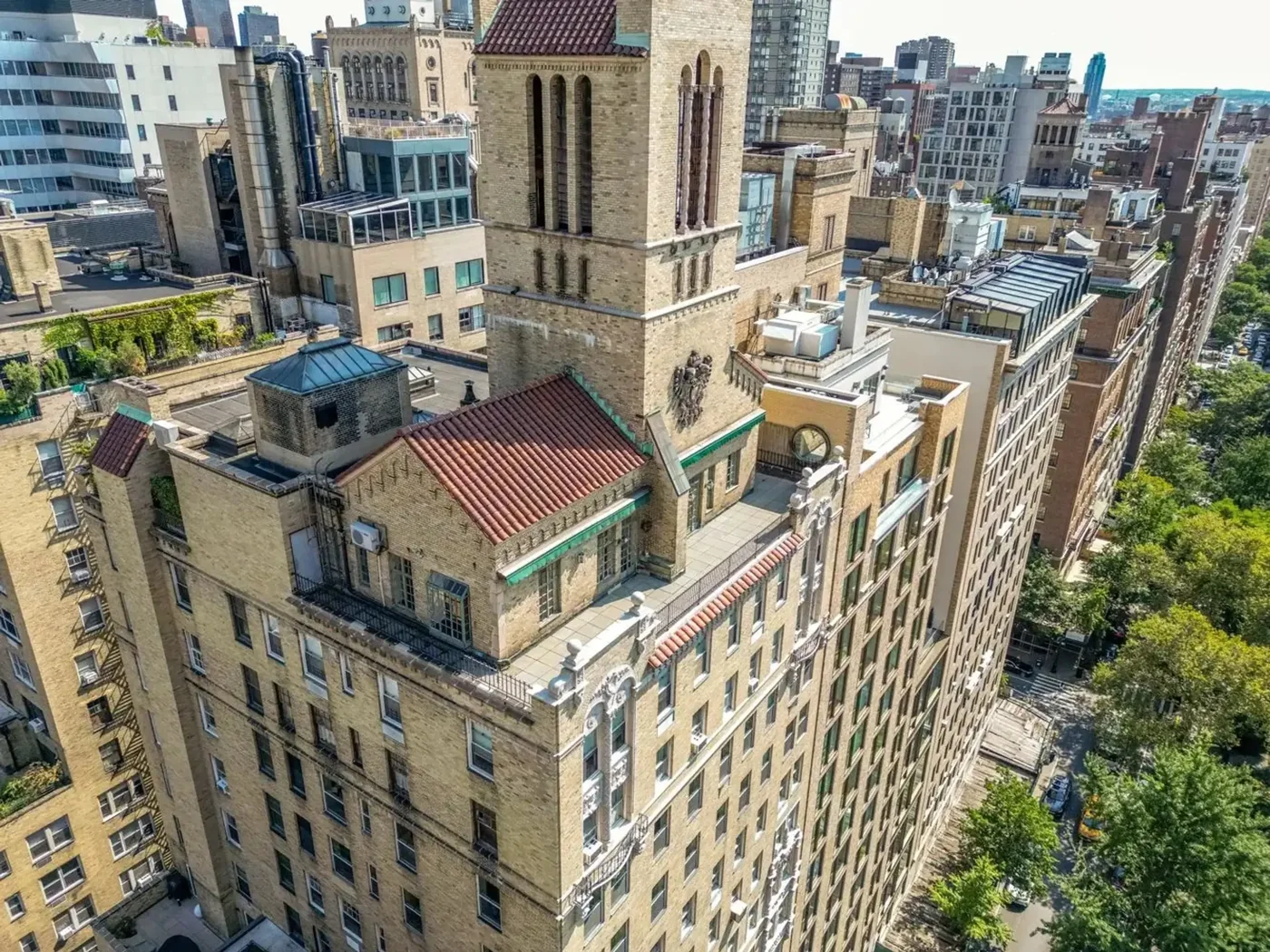 An elevated view of red-tiled roofs, terraces, the ornamental tower and the Park below.