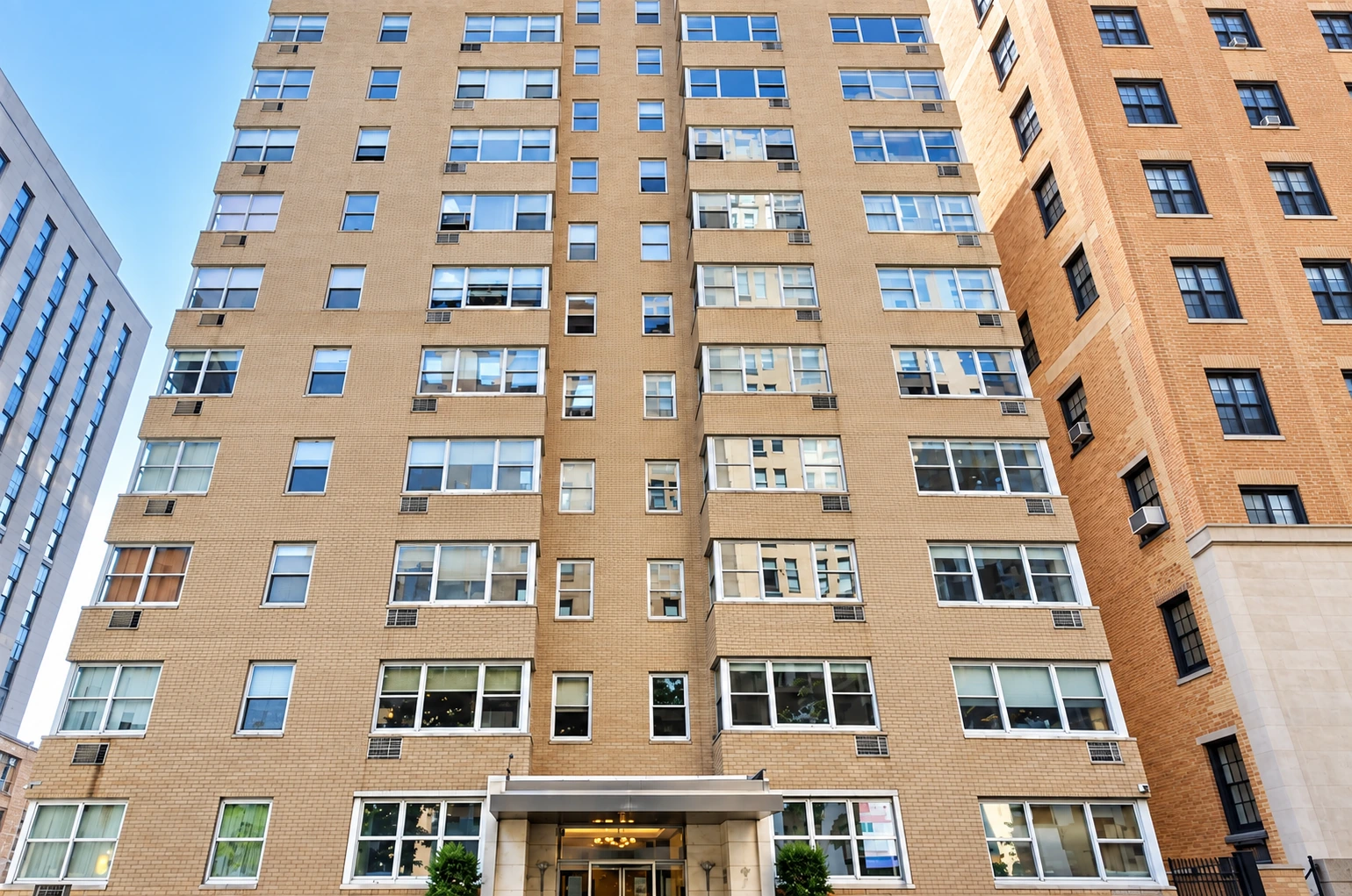 The pale brick facade of The Park Gramercy at 7 Lexington Avenue