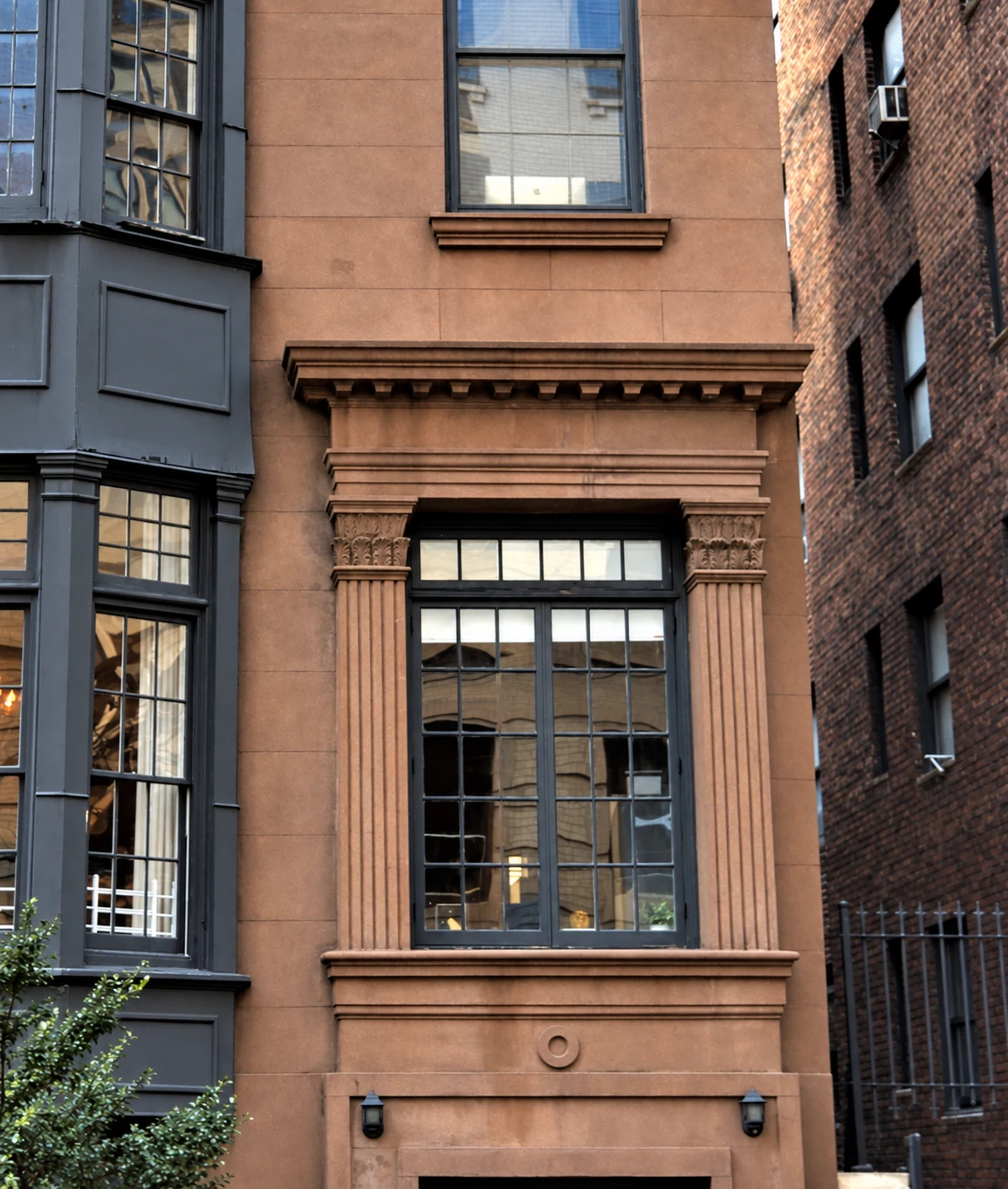 Fluted pilasters and leaf-carved capitals frame the former entrance, now a window, at 9 Gramercy Park South.