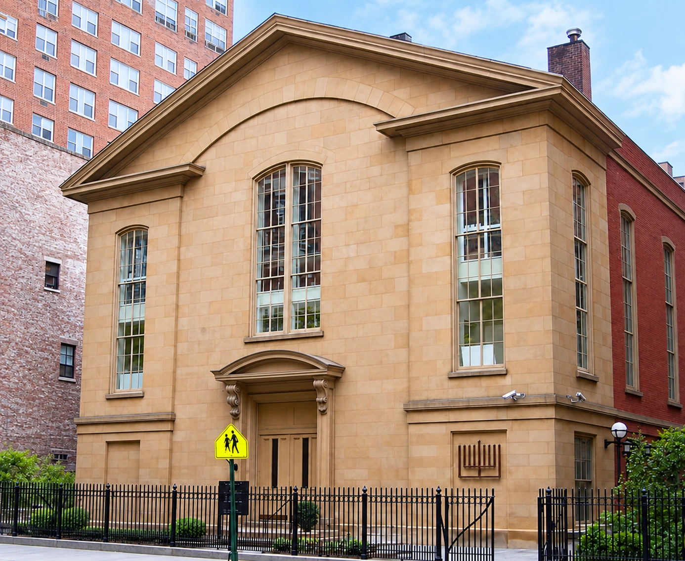 The stone facade and triangular pediment of Brotherhood Synagogue, with the entrance facing Gramercy Park.