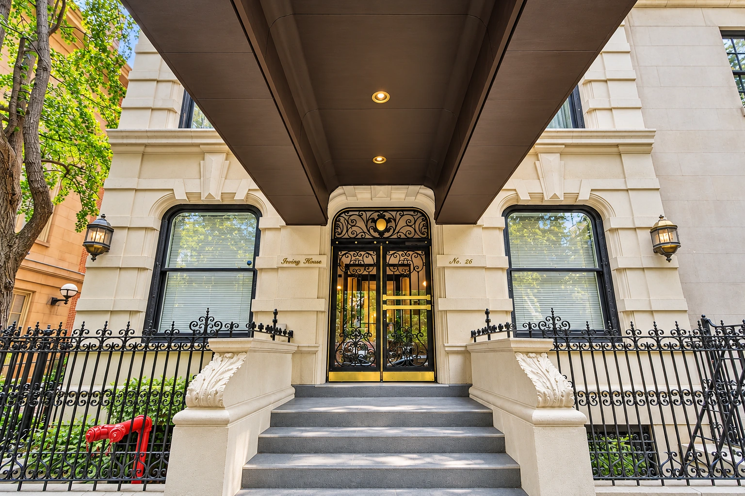 The Irving House entrance, with ornamental ironwork, brass detailing and carved stone stair walls