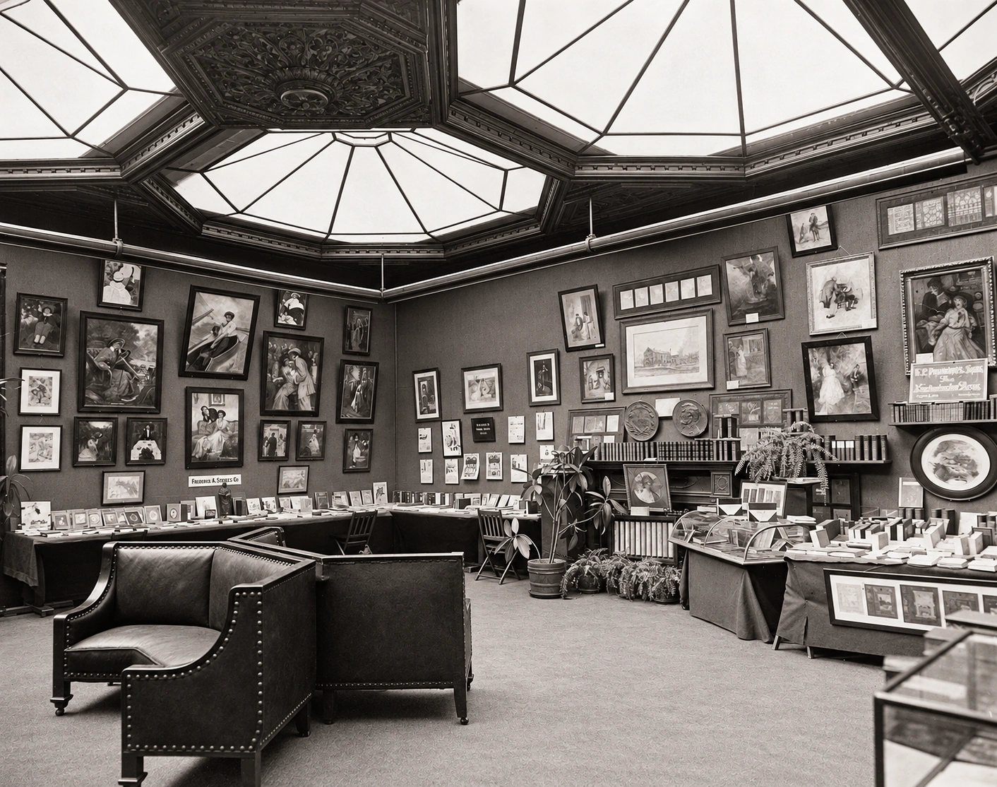 An archival National Arts Club interior with framed pictures, displays of books and decorative objects, carved ceiling panels and leather chairs.