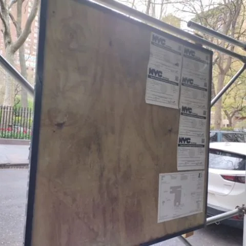 The construction notice board with graffiti removed.