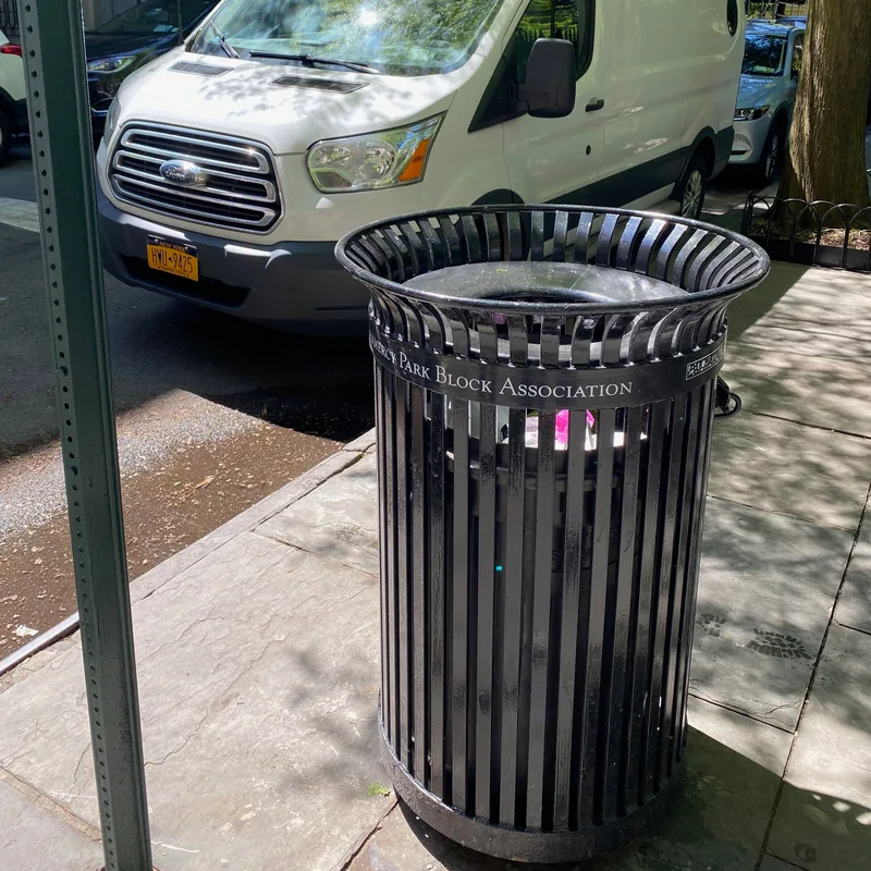 The curbside litter basket emptied and lined.