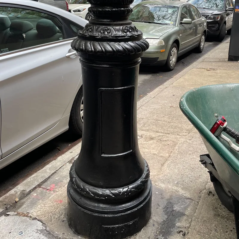 The lamppost base repainted black, with the chain removed.