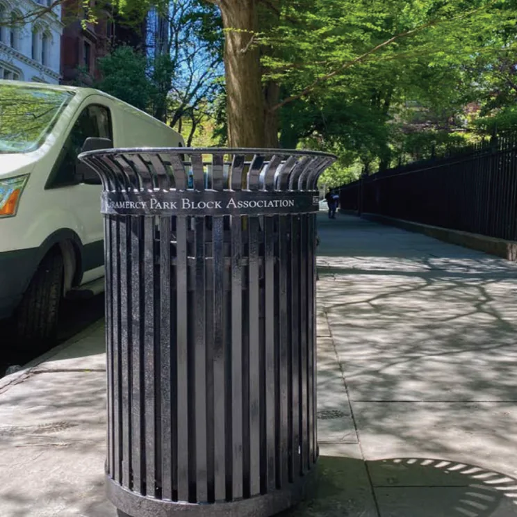 The litter basket emptied along the Park fence.