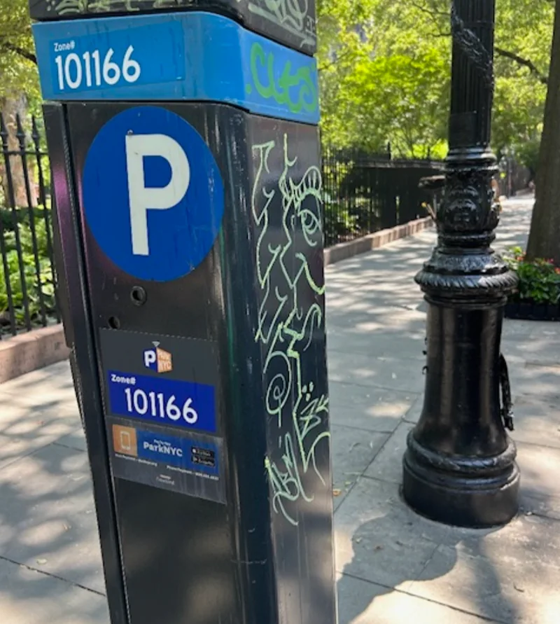 Graffiti on the front and side of parking meter 101166.