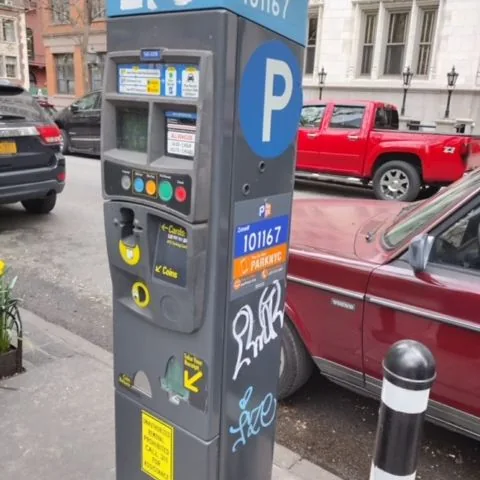 White and blue graffiti on parking meter 101167.