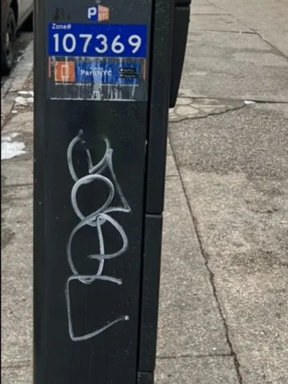 White graffiti on parking meter 107369.