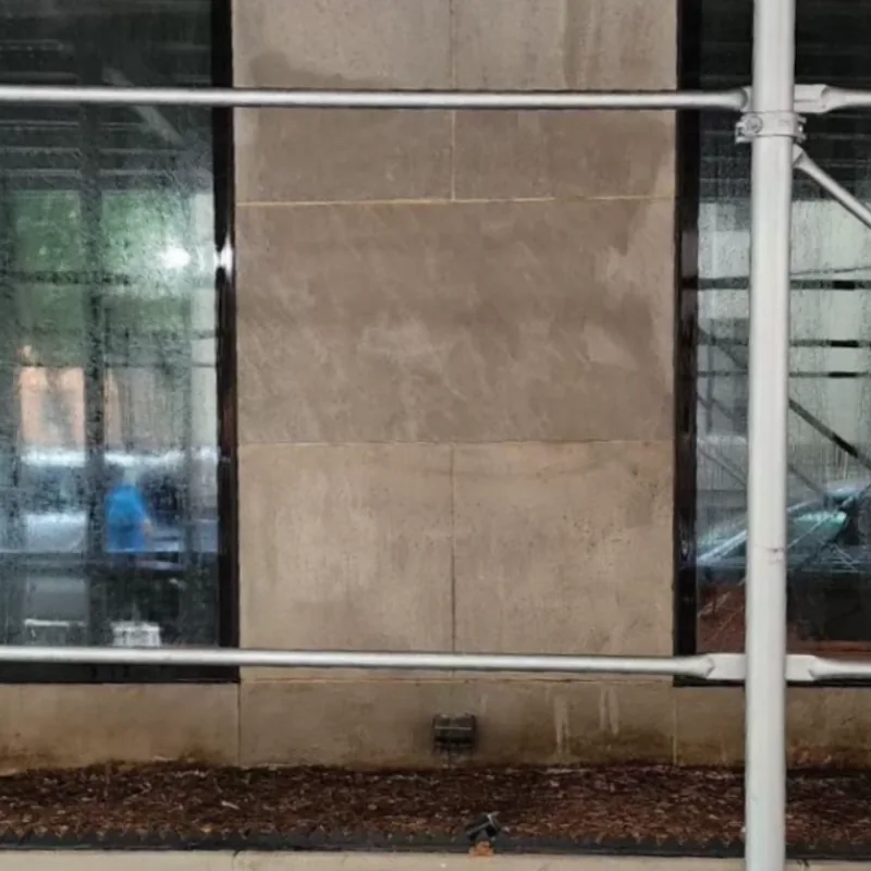 The stone facade with the graffiti removed.