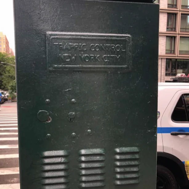 The traffic control cabinet repainted dark green.