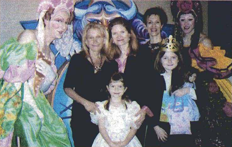 Children and adults gather with ballet performers in costume.
