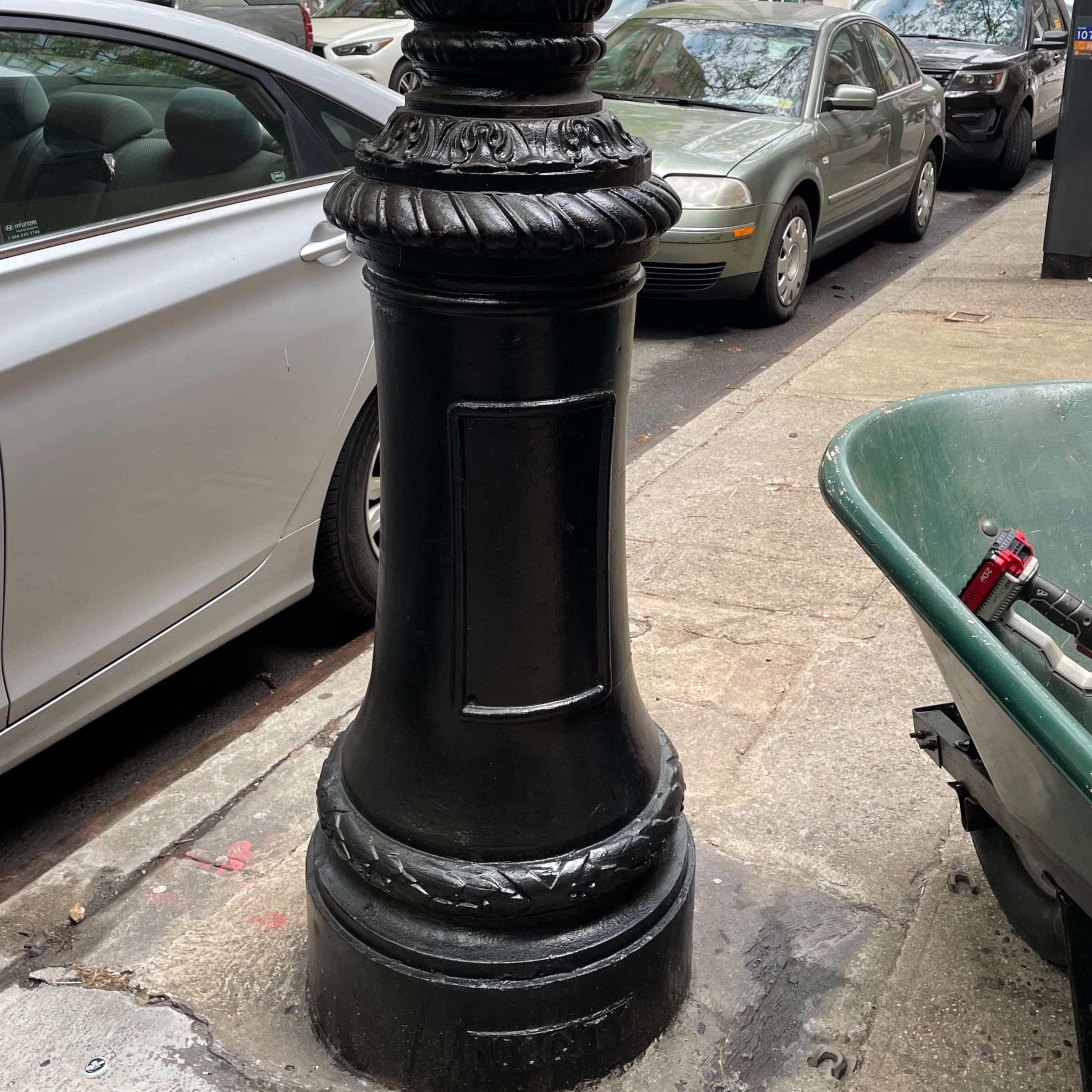 The matching lamppost base is clean and uniformly black after maintenance.