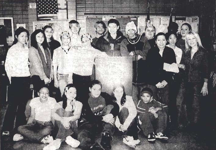 Arlene Harrison stands with young people and officers at a precinct gathering.