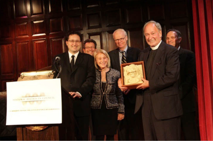 Tom Pike receives a framed award with civic and preservation colleagues.
