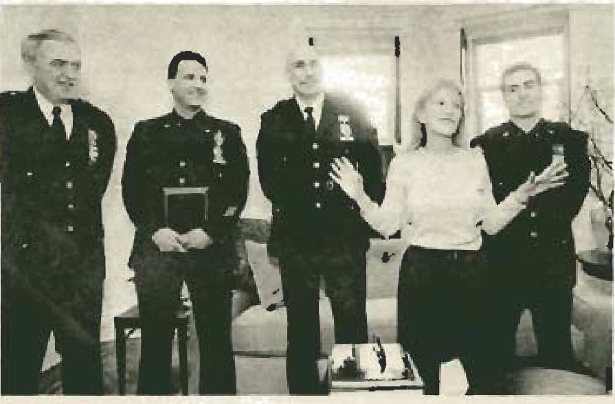 Arlene Harrison addresses a gathering alongside police officers.