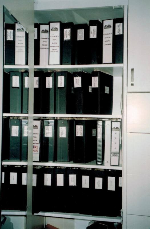 Cabinet shelves holding labeled the Block Association binders.
