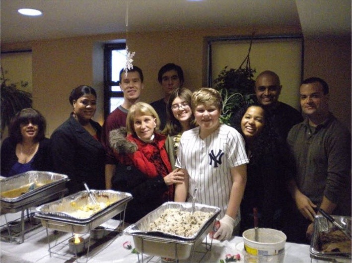 Kenmore staff and the Block Association’s volunteers stand behind trays of food.