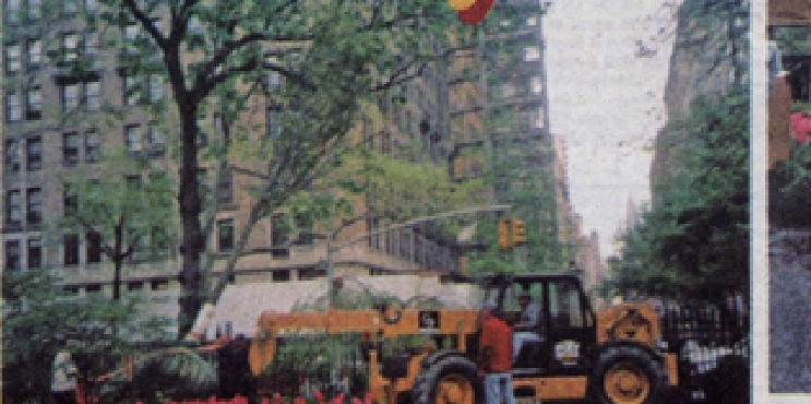 Large equipment moves a tree beside Gramercy Park.