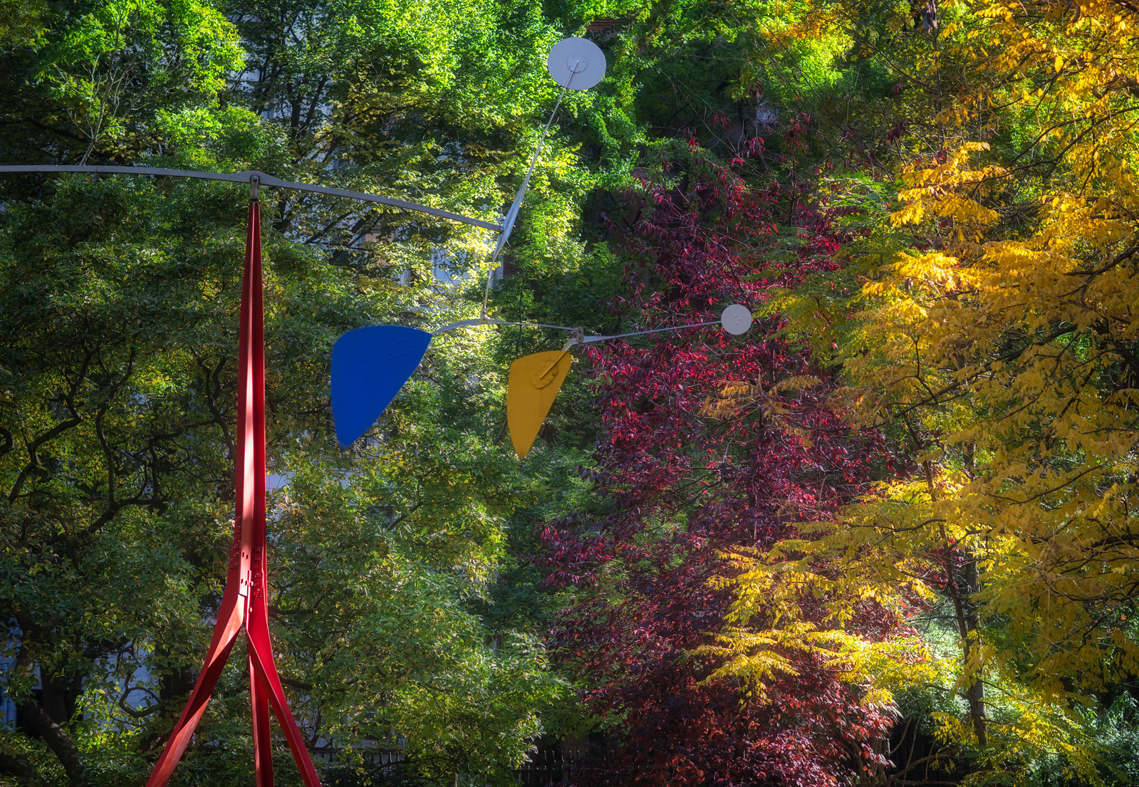 Alexander Calder’s Janey Waney amid green and gold autumn foliage in Gramercy Park.