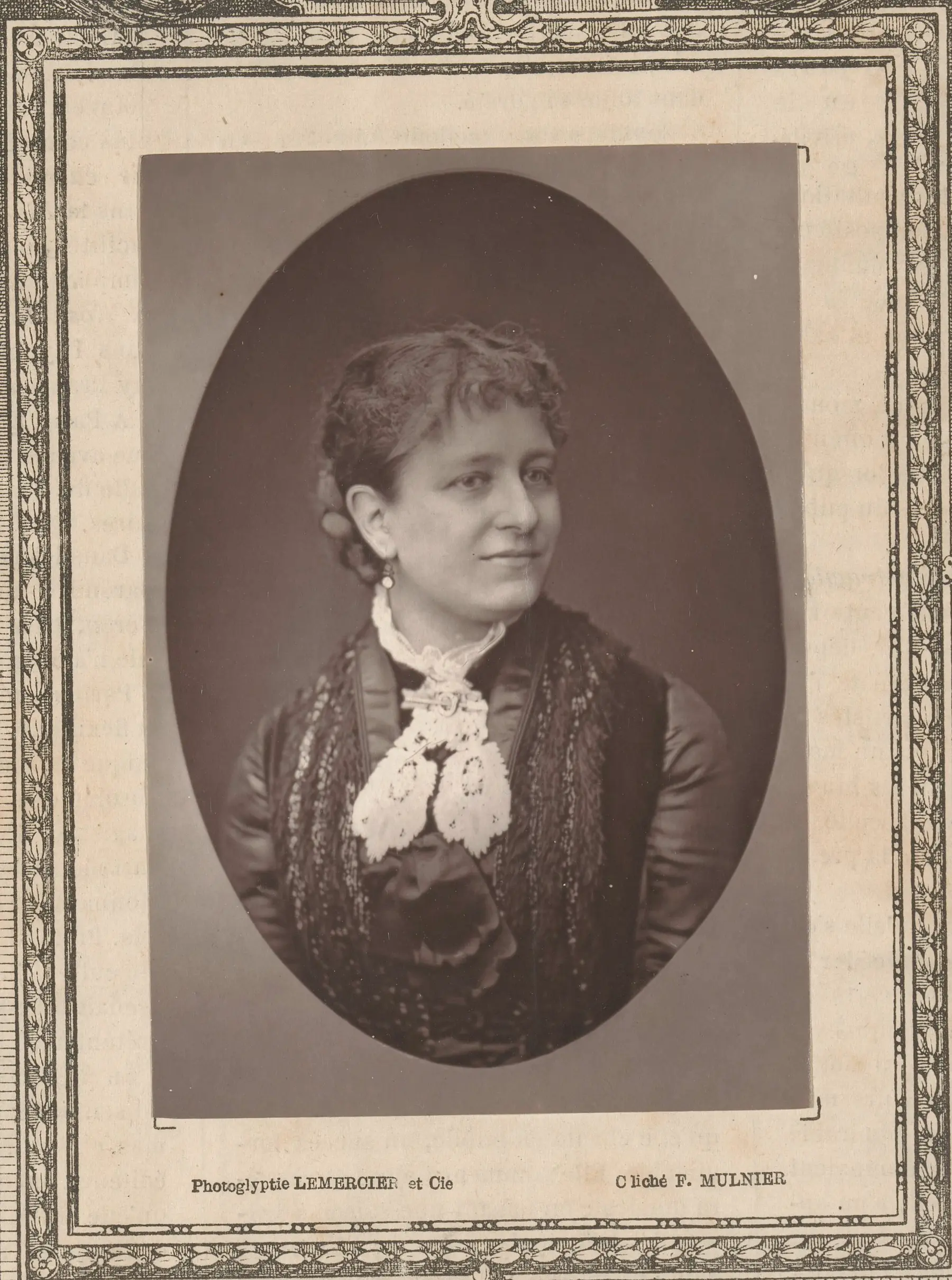 Studio portrait of a young Emma Thursby in dark dress with white lace bow, photographed by Ferdinand Mulnier, ca. 1878–1879.
