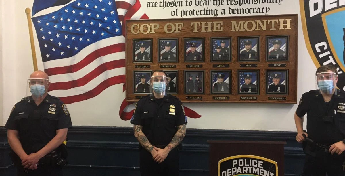 Officers wearing face shields supplied through the neighborhood partnership.