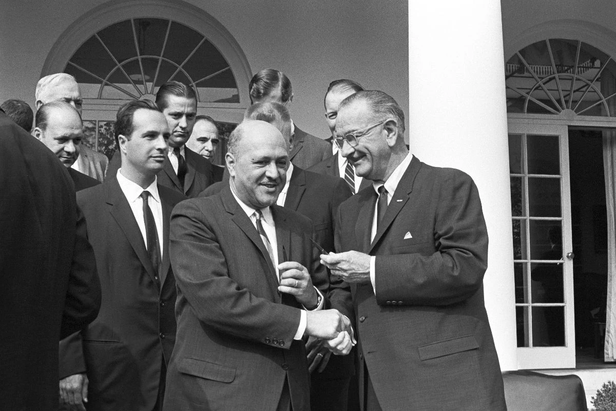 Robert Weaver with President Lyndon B. Johnson and other officials.